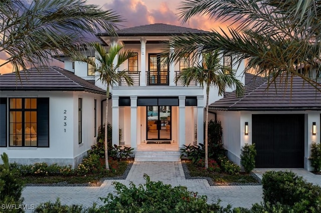 exterior entry at dusk with a balcony