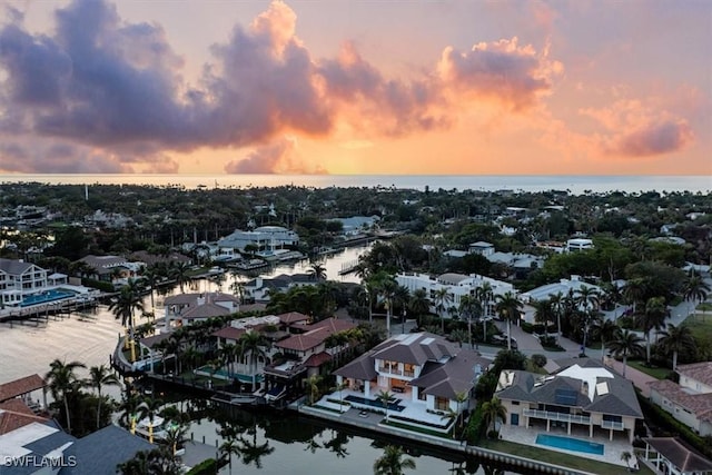 aerial view at dusk with a water view