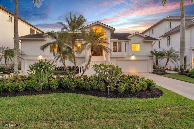 view of front of house with a yard and a garage