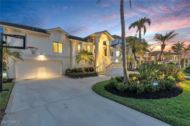 view of front of house featuring a garage and a lawn