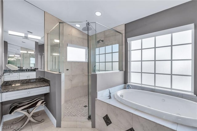 bathroom with tile patterned flooring, vanity, a wealth of natural light, and plus walk in shower