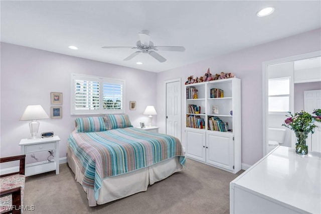 bedroom with ceiling fan and light carpet