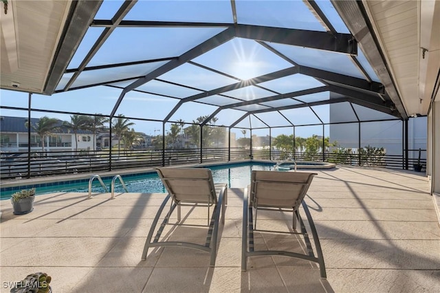 view of swimming pool featuring glass enclosure and a patio area