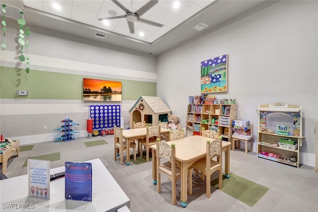 game room with carpet flooring and ceiling fan