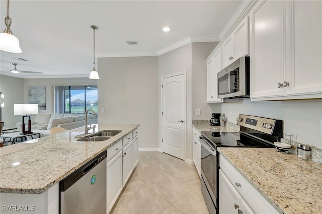 kitchen featuring stainless steel appliances, white cabinetry, a center island with sink, and sink