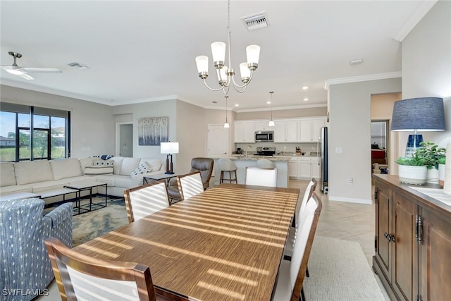 tiled dining room featuring ceiling fan with notable chandelier and ornamental molding