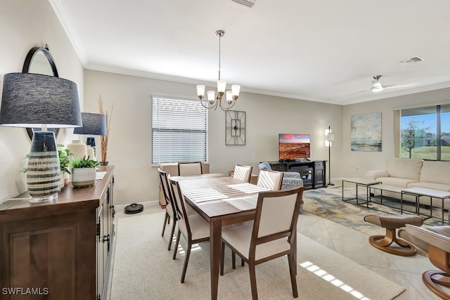 dining space featuring a wealth of natural light, crown molding, light tile patterned flooring, and ceiling fan with notable chandelier