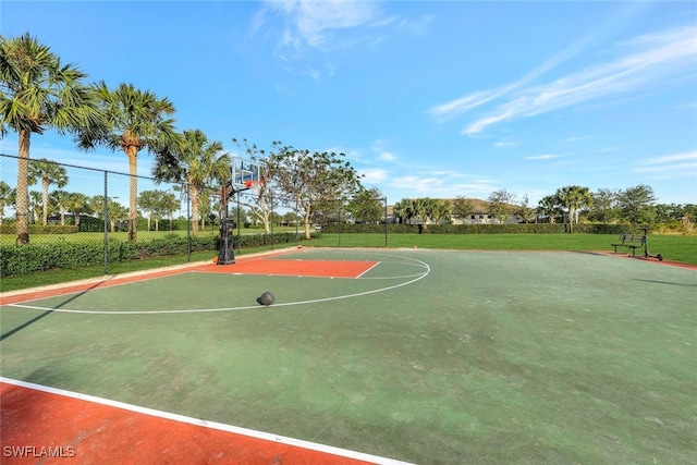 view of basketball court with a yard