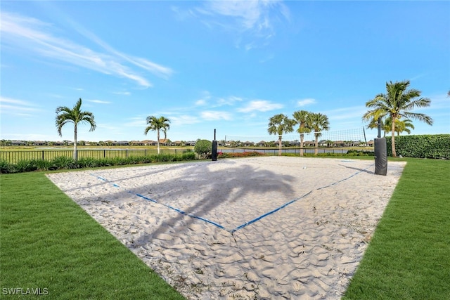 view of property's community with volleyball court and a yard