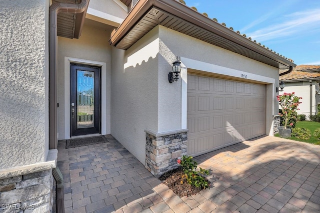 doorway to property with a garage