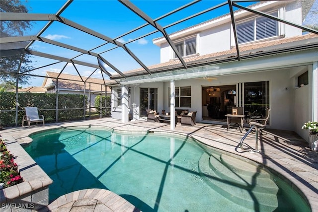 view of pool with ceiling fan, a patio area, a lanai, and an outdoor hangout area