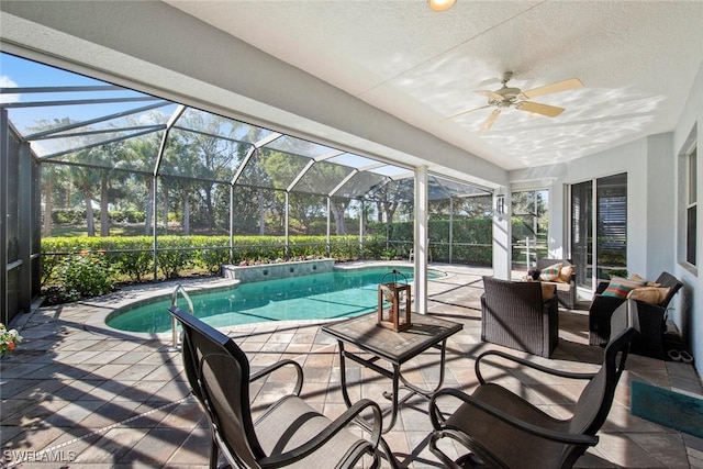 view of swimming pool with a patio, ceiling fan, and a lanai