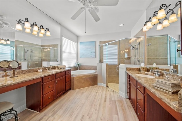 bathroom with ceiling fan, hardwood / wood-style floors, vanity, and independent shower and bath