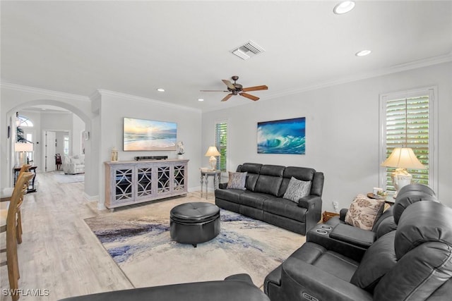 living room with hardwood / wood-style floors, ceiling fan, and ornamental molding