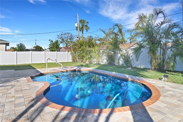 view of swimming pool featuring a lawn and a patio area