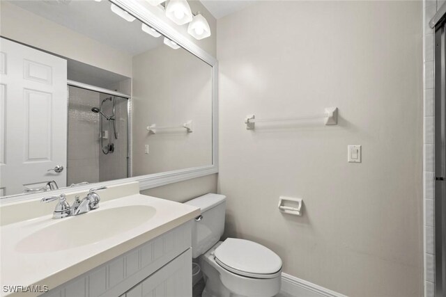 bathroom with toilet, vanity, and walk in shower