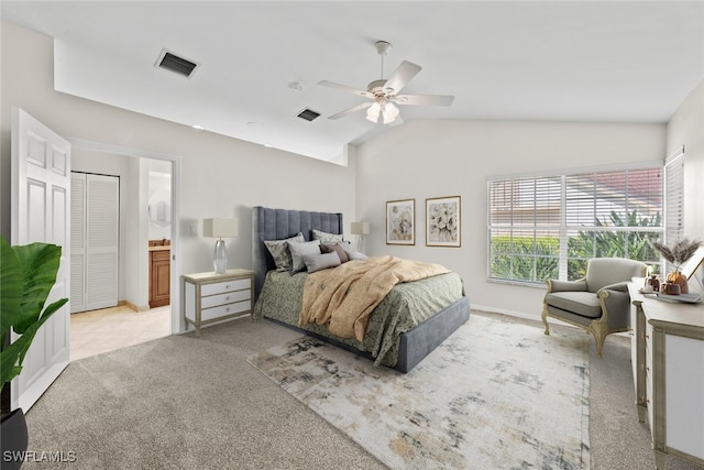 carpeted bedroom with ensuite bath, ceiling fan, and lofted ceiling