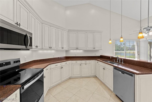 kitchen with light tile patterned floors, a peninsula, stainless steel appliances, high vaulted ceiling, and a sink