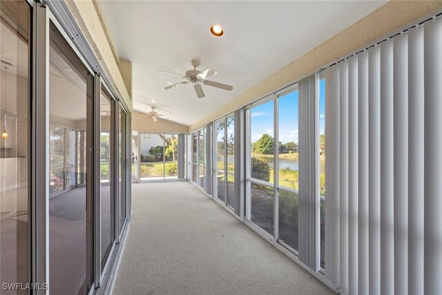 unfurnished sunroom with ceiling fan and vaulted ceiling