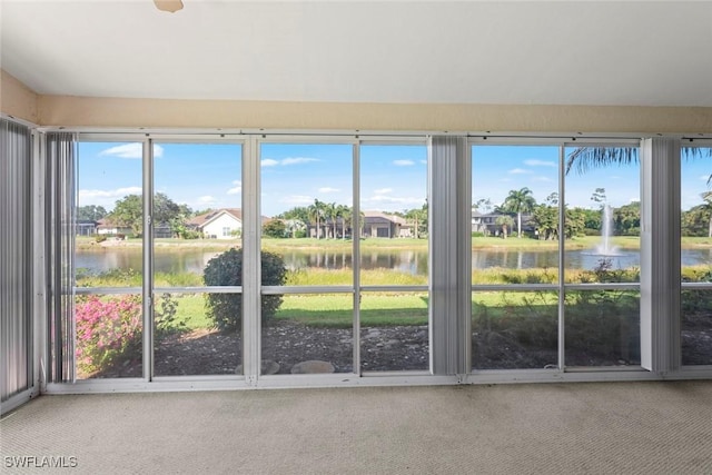 unfurnished sunroom with a water view