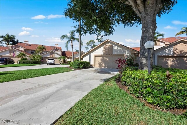 view of front of property with a front lawn and a garage