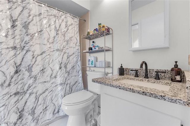 bathroom featuring vanity, toilet, and walk in shower