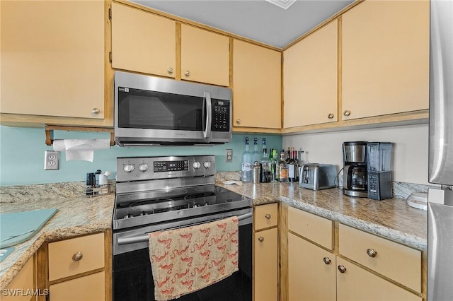 kitchen with stainless steel appliances and light brown cabinetry