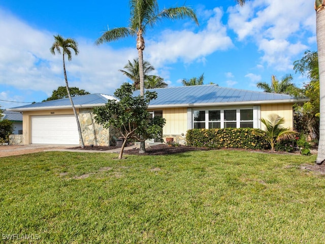 ranch-style house featuring a front lawn and a garage