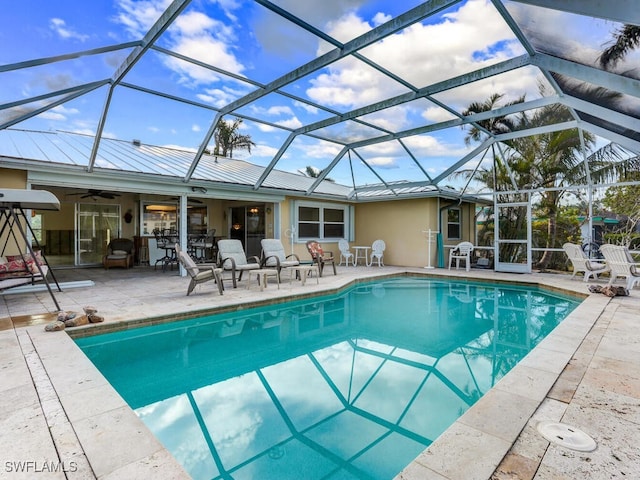 1660 Sandpiper St, Naples, FL 34102 - swimming pool with a patio area, a ceiling fan, and glass enclosure