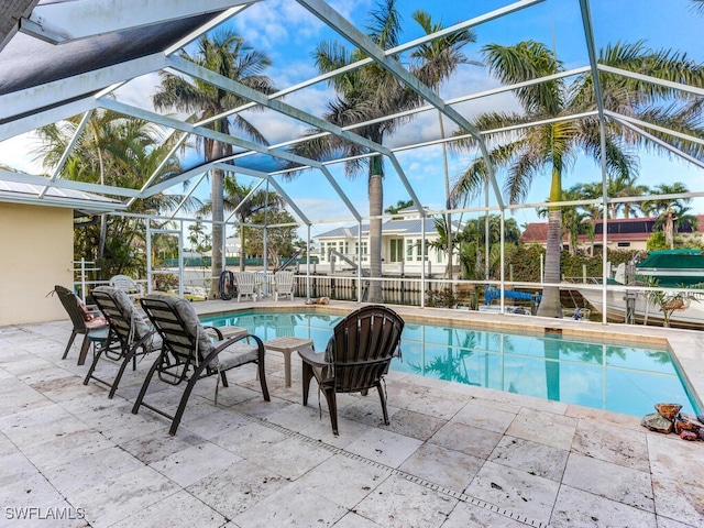 1660 Sandpiper St, Naples, FL 34102 - swimming pool featuring glass enclosure and a patio area