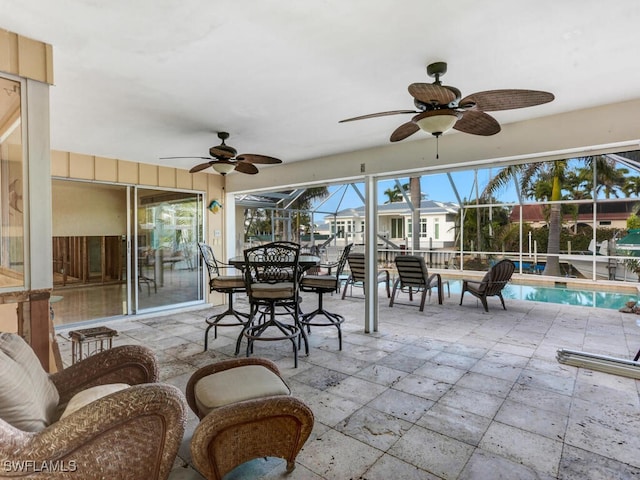 sunroom featuring ceiling fan