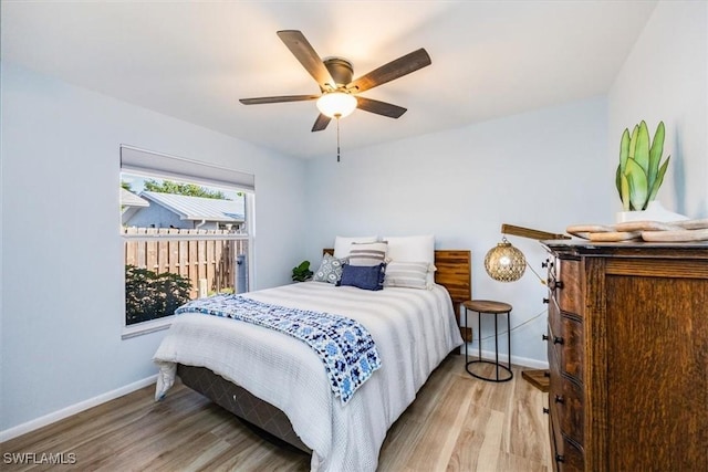 bedroom with ceiling fan and light hardwood / wood-style flooring