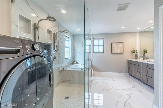 bathroom with separate shower and tub, vanity, and washer / dryer