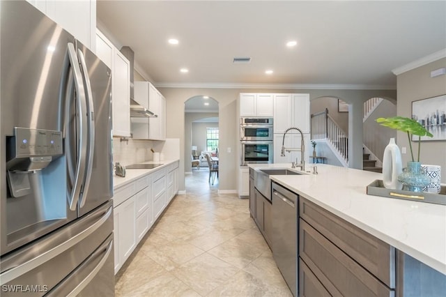 kitchen featuring white cabinetry, sink, stainless steel appliances, backsplash, and ornamental molding