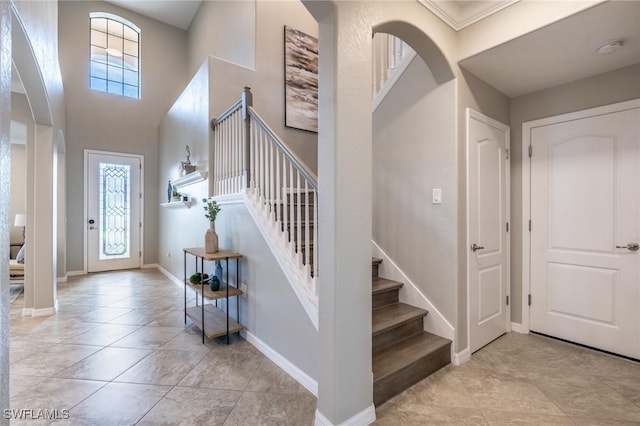 tiled foyer entrance with ornamental molding