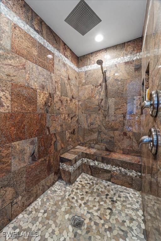 bathroom with a tile shower