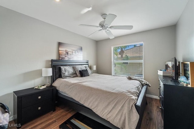 bedroom with dark hardwood / wood-style flooring and ceiling fan