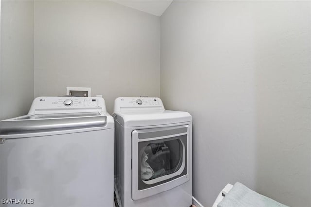 clothes washing area featuring independent washer and dryer