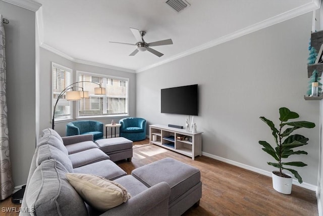 living room featuring hardwood / wood-style floors, ceiling fan, and crown molding