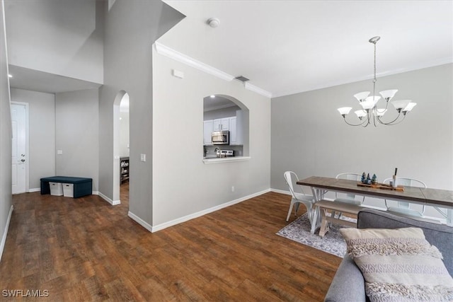 dining area with arched walkways, wood finished floors, baseboards, an inviting chandelier, and crown molding