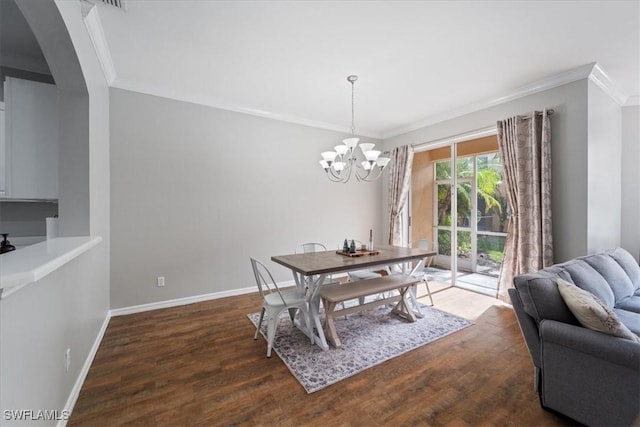 dining area with crown molding, dark hardwood / wood-style flooring, and a notable chandelier