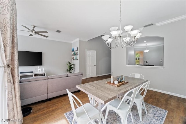 dining space with ceiling fan with notable chandelier, visible vents, wood finished floors, and ornamental molding