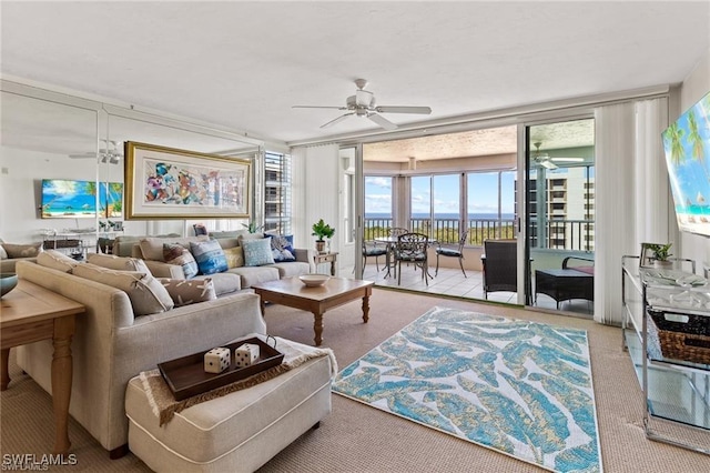 living room with ceiling fan and floor to ceiling windows