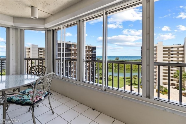 unfurnished sunroom with a water view and a healthy amount of sunlight