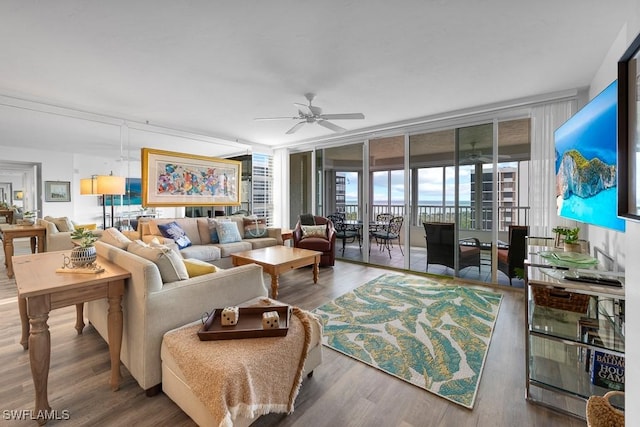 living room featuring hardwood / wood-style floors, ceiling fan, and floor to ceiling windows