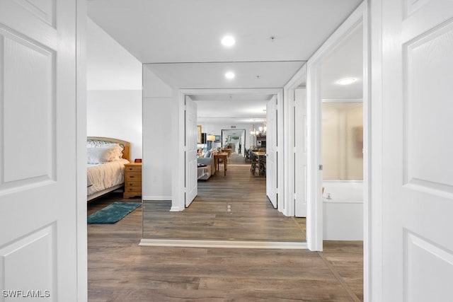 hallway with dark hardwood / wood-style flooring