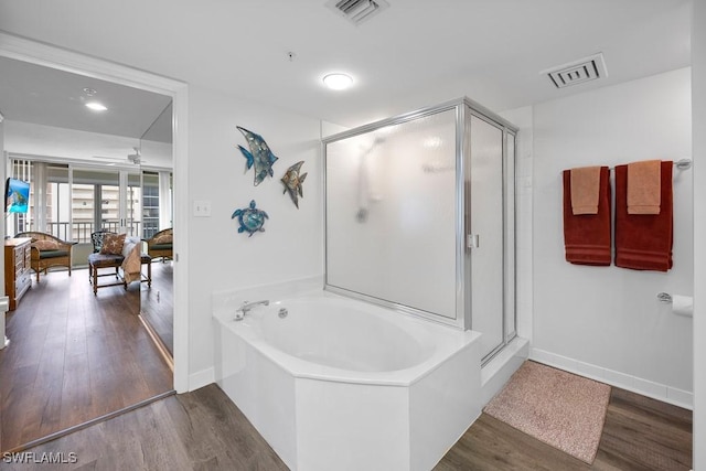 bathroom with separate shower and tub and hardwood / wood-style floors