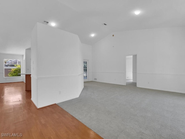 empty room featuring carpet flooring and high vaulted ceiling