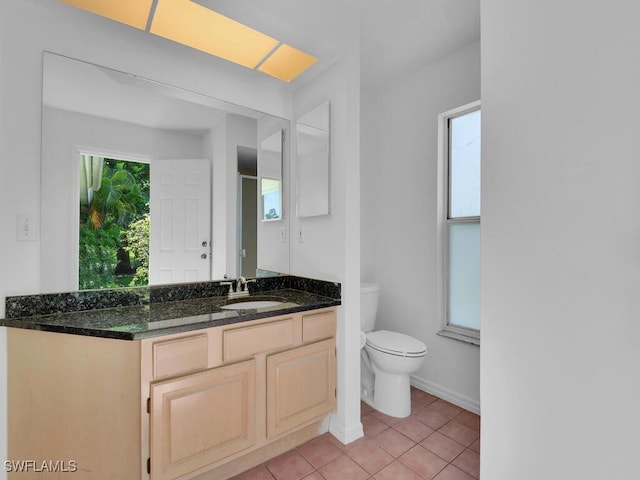 bathroom with tile patterned floors, vanity, and toilet