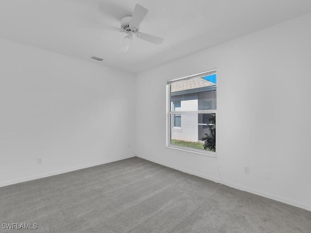 empty room with ceiling fan and light colored carpet